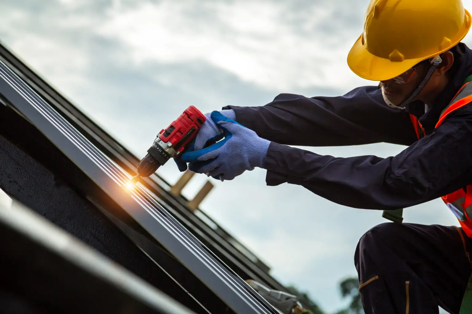 roofer-worker-protective-uniform-wear-gloves-construction-worker-install-new-roof-roofing-tools-electric-drill-used-new-roofs-with-metal-sheet-1536x1024